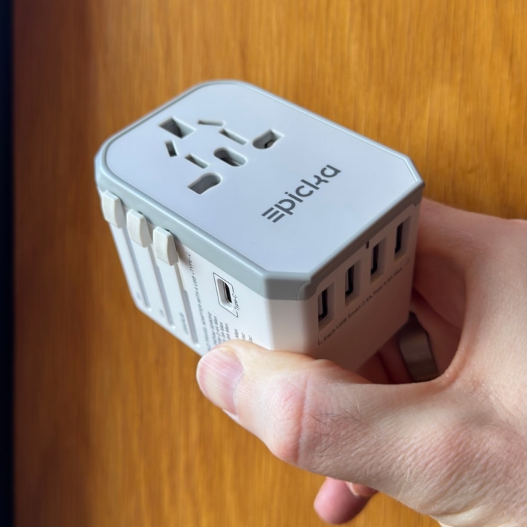 Man holding the Epicka Universal Travel Adapter.