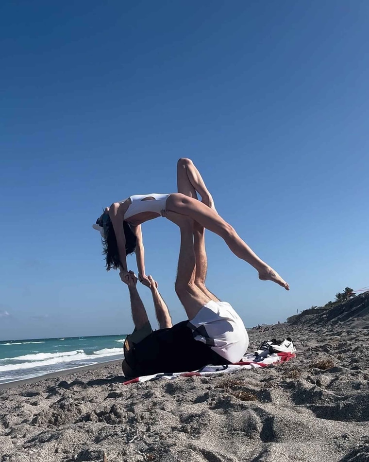 Bill Belichick and Jordon Hudson practicing their moves on the beach.