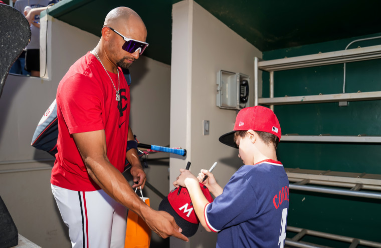 Young Twins fan signs Royce Lewis' hat.