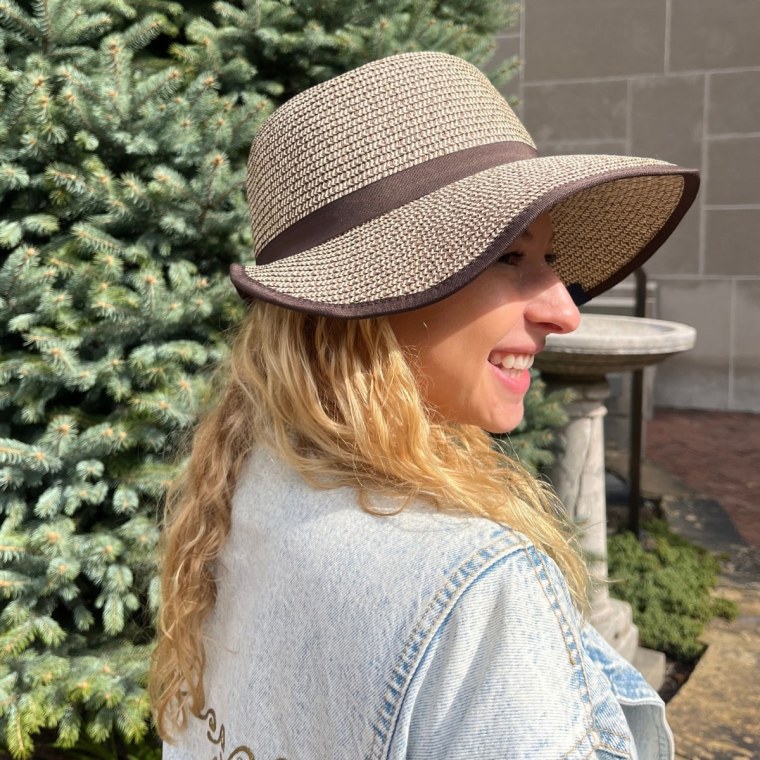 Producer Eden Strassburg tries the Lands' End Facesaver Sun Hat.