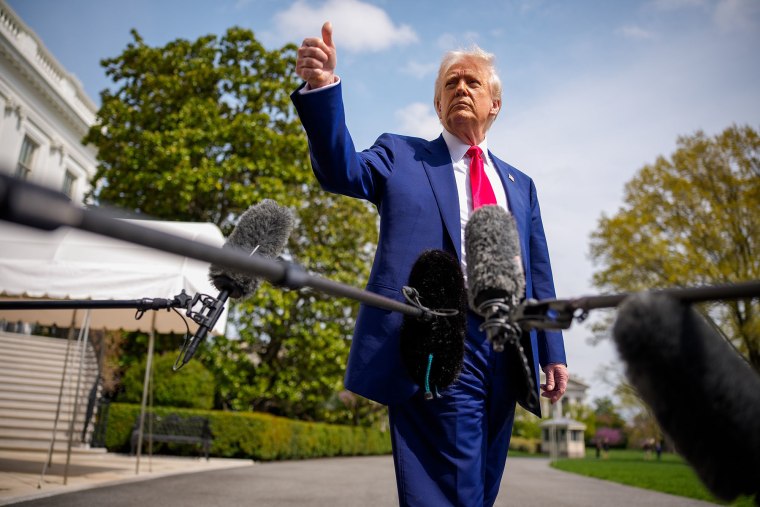 President Donald Trump gestures to members of the media before boarding Marine One on the South Lawn of the White House on April 3, 2025.