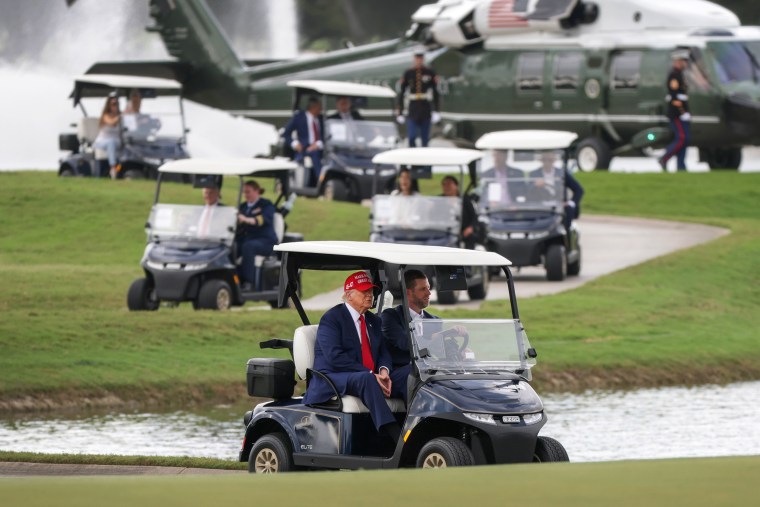 Eric Trump drives President Trump in golf cart