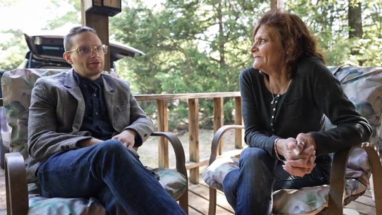 Douglas, left, and Wendy sit on a porch outside