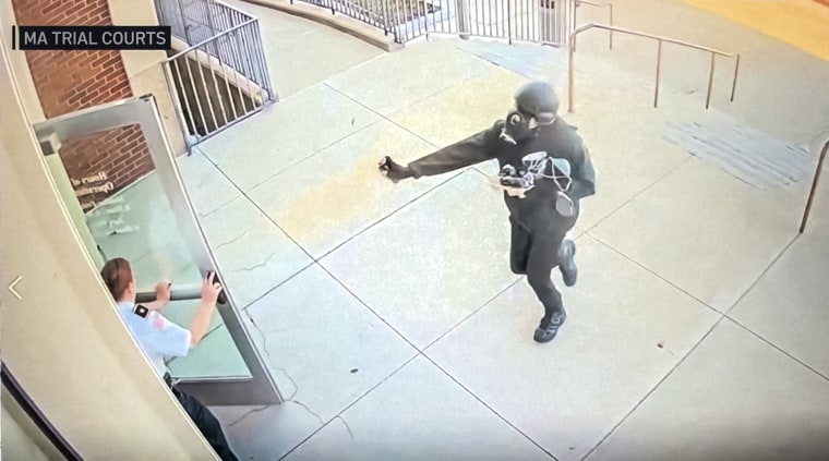 Nicholas Akerberg, of Yarmouth Port, deploying pepper spray as he enters Woburn District Court on April 14, 2025, in a suburb of Boston.