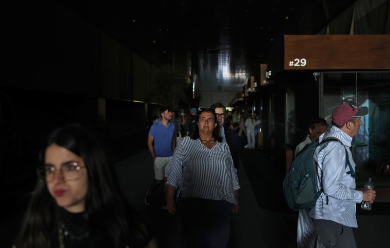 Fans walk through a dark hallway at the Madrid Open on April 28, 2025 in Spain.