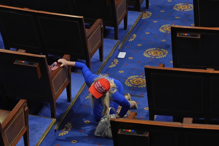 Rep. Marjorie Taylor Greene, R-Ga., looks for her phone after President Donald Trump departed after addressing a joint session of Congress