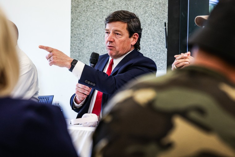 Ed Martin speaks and points while seated