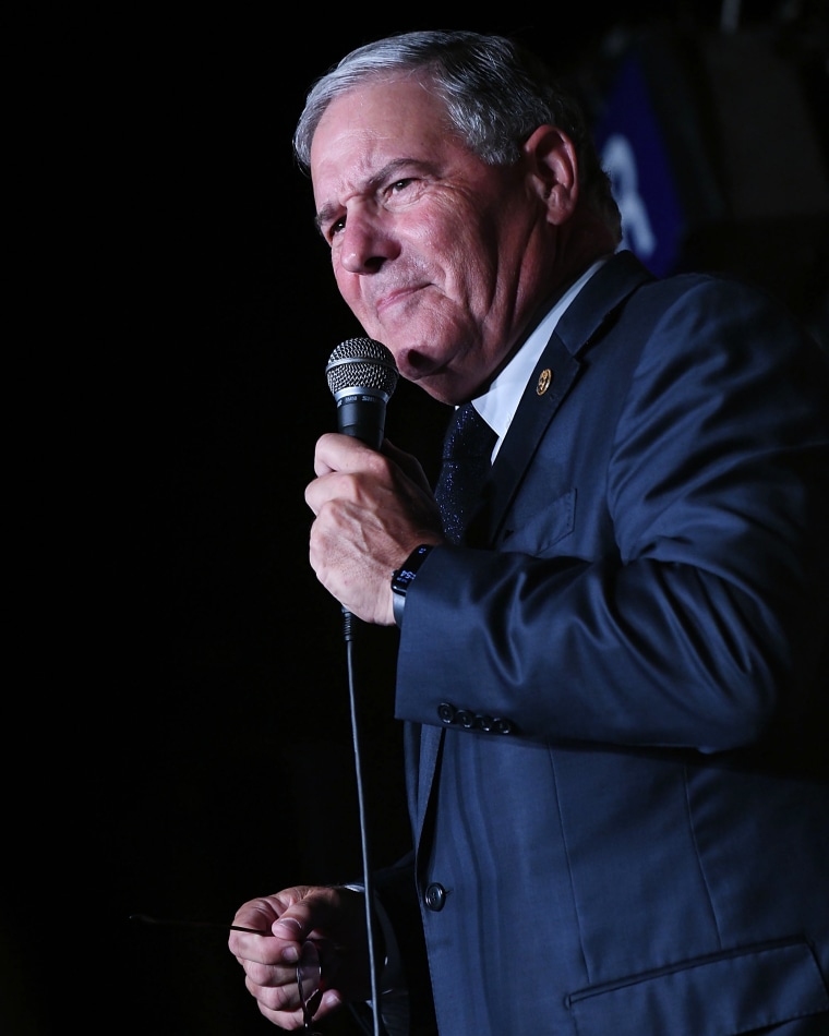 New Jersey Sen. Jon Bramnick holds a microphone