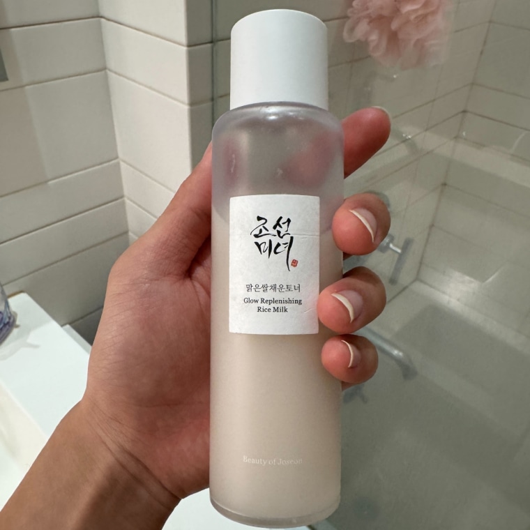 A hand holding the Beauty of Joseon Glow Replenishing Rice Milk Toner