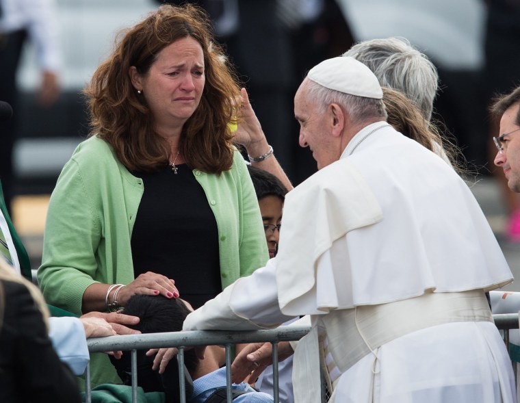 Kristin Keating cries as Pope Francis blesses her disabled son, Chuck Keating, upon arrival in Philadelphia on September 26, 2015, on the final leg of his six-day visit to the US. Chuck Keating suffers from cerebral palsy.