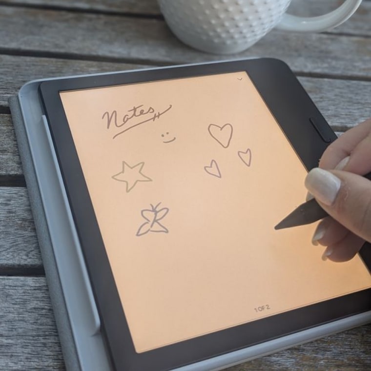A close up image of someone using a stylus to draw doodles on the Kobo Libra Colour.