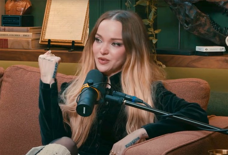 Dove Cameron shows off a tattoo on her hand that sats "We'll be friends forever" during a recent episode of Dax Shepard's "Armchair Expert" podcast.