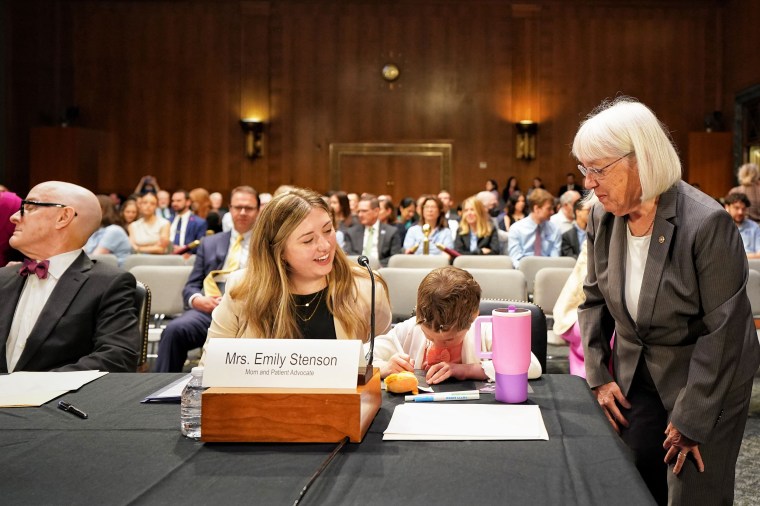 Emily Stenson with her daughter, Charlie, at a Senate Appropriations Committee hearing to make the case against proposed cuts to the National Institutes of Health at the Capitol on April 30.