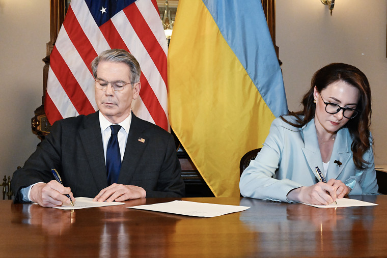 Scott Bessent, the U.S. Treasury secretary, and Yulia Svyrydenko, a Ukraine deputy minister, signing the minerals deal.Credit...