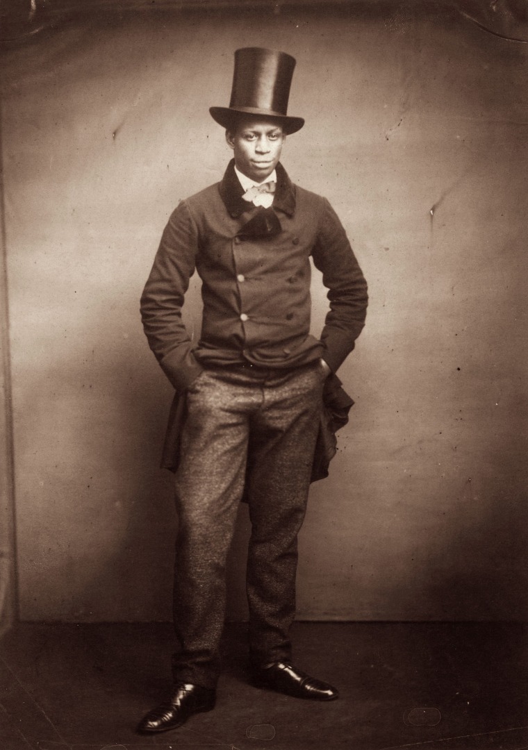 A young man wearing a formal suit and top hat circa 1890.