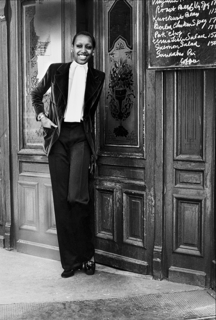 Model Amina photographed for Vogue in a velvet blazer and black satin pants by Yves Saint Laurent in 1972.