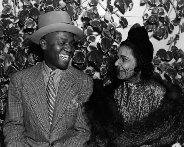 Bill Robinson, the American tap-dancer and entertainer renowned for his stairway dance, sharing a joke with a friend at the Trocadero cafe circa 1927.