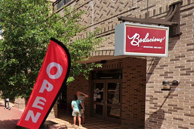 People standing outside Bodacious Bookstore and Cafe.