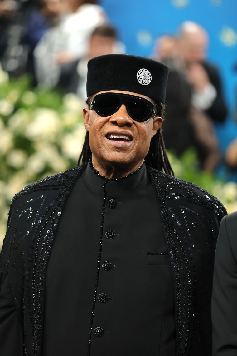 Isn't he lovely? Stevie Wonder hits the Met Gala carpet in an all-black ensemble.