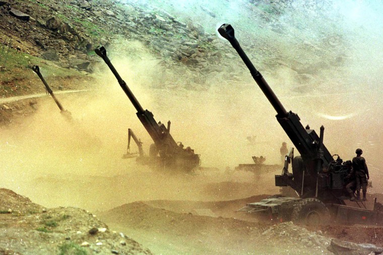 Indian artillery men fire three 155mm Bofors guns at enemy positions from a gun emplacement in the Drass sector of Indian-controlled Kashmir