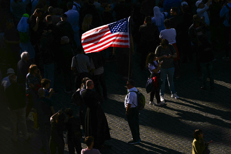Image: People wait for the smoke signaling the result of the cardinals' vote at St Peter's square