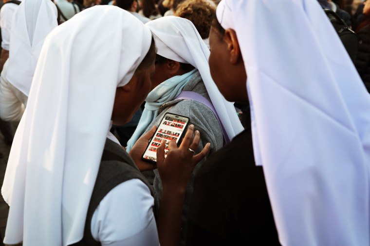 Nuns check their phone