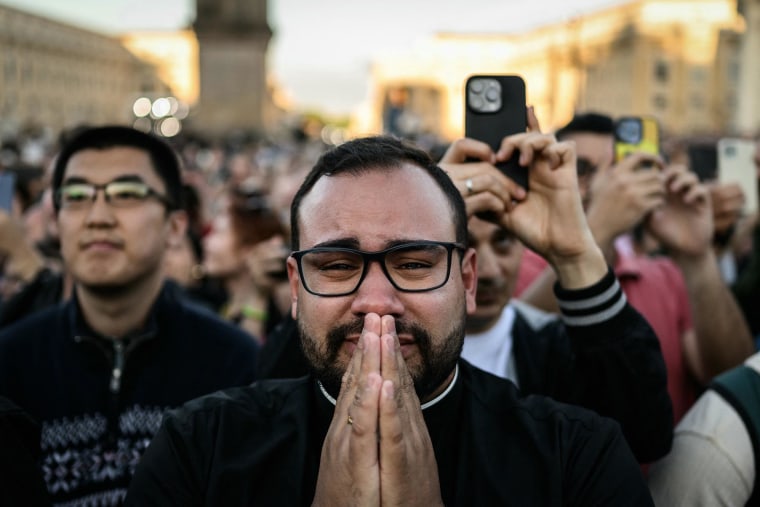 A man reacts as the newly elected Pope Leo XIV, Robert Prevost, maks his first appearance in the main central loggia balcony of the St Peter's Basilica on May 8, 2025.