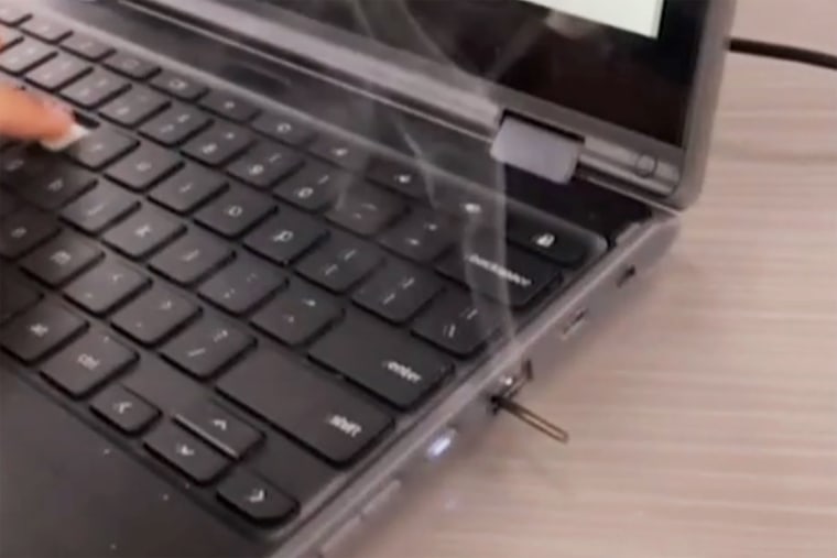 A Chromebook smoulders after being tampered with.