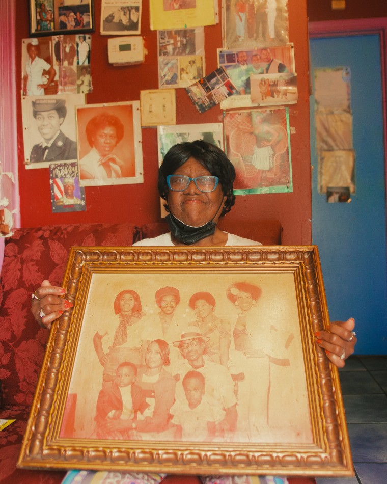 In a home adorned with photos, Easter Knox holds a family portrait.