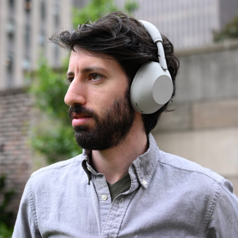 Close up, in-profile shot of the Sony WH-1000XM6 headphones worn by the writer.