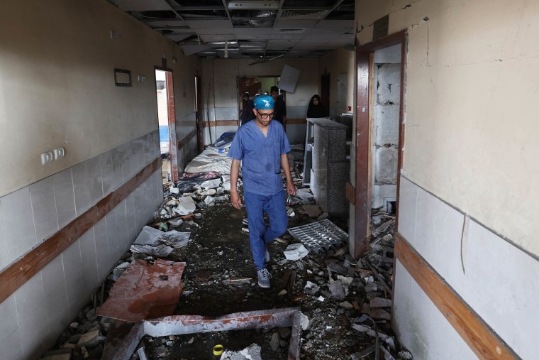 Palestinian hospital staff inspect the destruction inside Nasser hospital