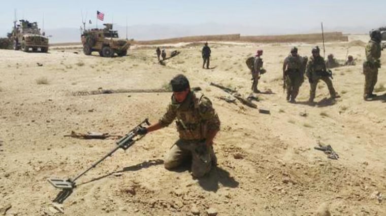 Abdul Rahman Waziri with a specialized metal detector to search for improvised explosive devices.
