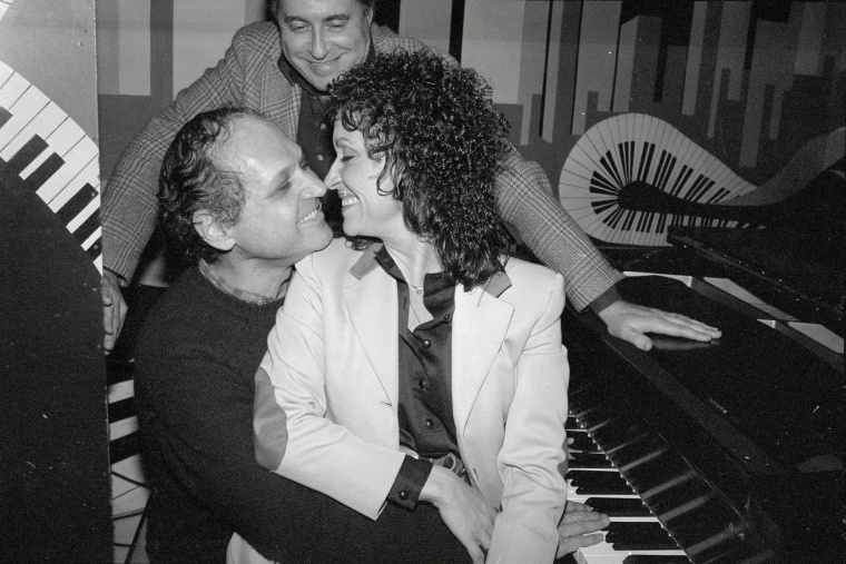 Chita Rivera showing affection with Charles Strouse, with Lee Guber stood behind them