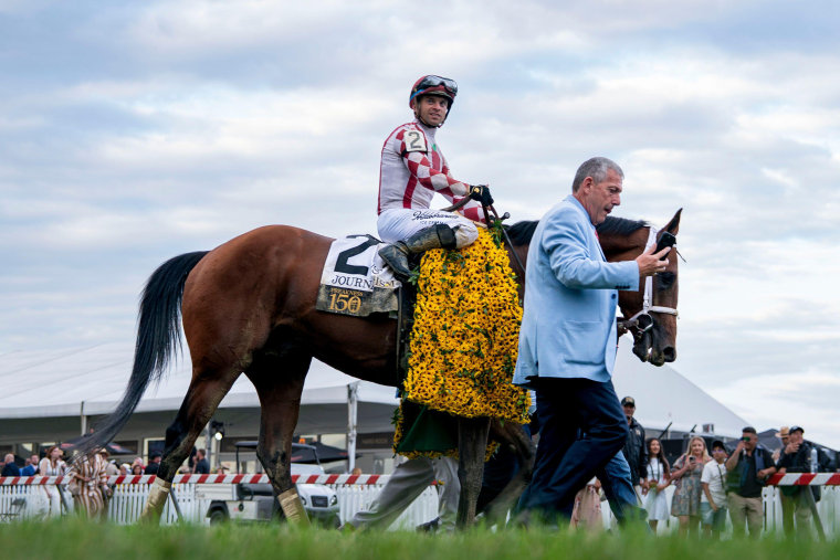 Jockey Umberto Rispoli rides to the winner's circle on #2 Journalism after winning the 150th Preakness Stakes at Pimlico Race Course
