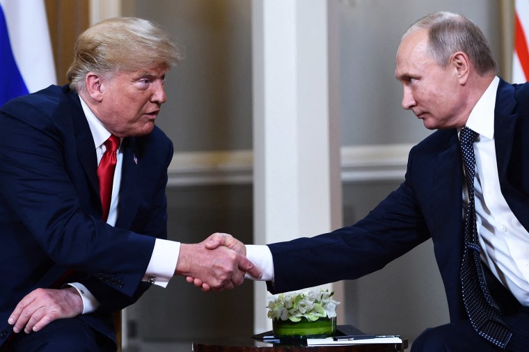 Russian President Vladimir Putin and US President Donald Trump shake hands.
