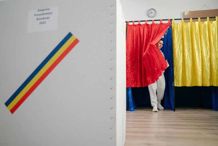 A voter holds her ballot paper