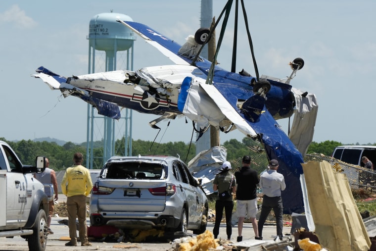 A Beechcraft T-34 is pulled from the rubble of a destroyed hangar at London-Corbin Airport