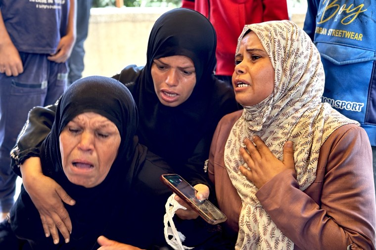 Loved ones grieve as they prepare to bury 10-year-old Ashraf Wafi after he was killed in an Israeli strike in Khan Younis, Gaza, on Tuesday.