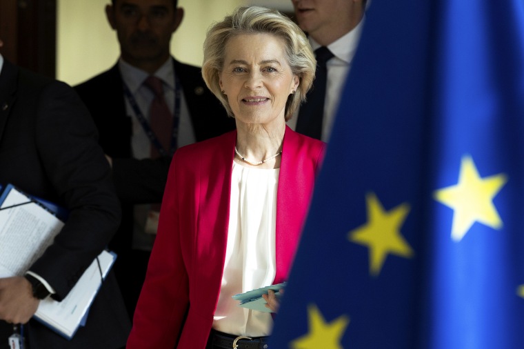 Ursula von der Leyen walking, the EU flag is pictured next to her