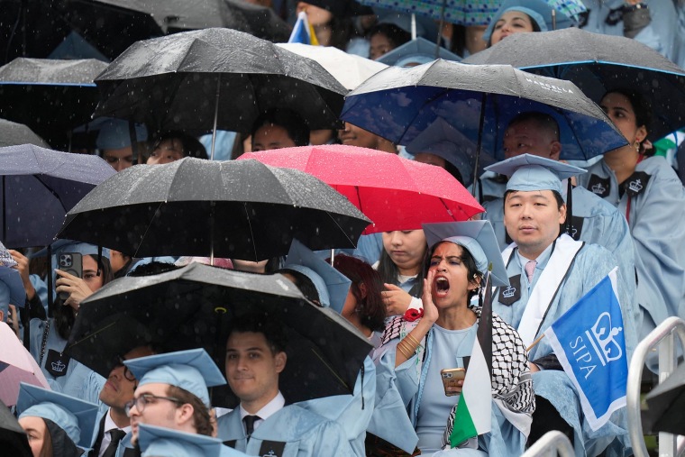 A student boos as Columbia University President Claire Shipman speaks during the commencement