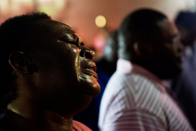 Lisa Doctor joins a prayer circle down the street from Emanuel AME Church after a 2015 shooting in Charleston, S.C.