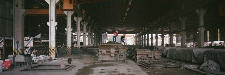 At Amaccao Concrete north of Hanoi, workers pack molds with wet mix.