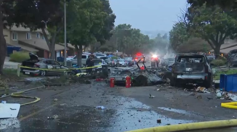 Damaged vehicles near the scene of a small plane crash in the Murphy Canyon neighborhood of San Diego.