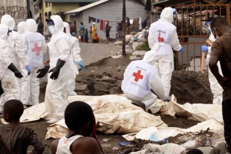 Screen grab of file video footage of humanitarian workers lifting body bags in Goma