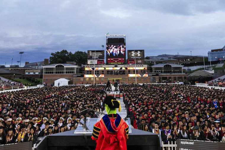 Kermit the Frog addressing a large crowd of graduates