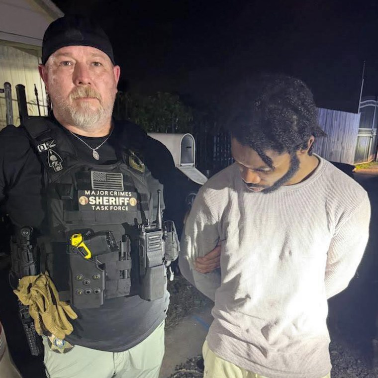 Dkenan Dennis, right, in custody.