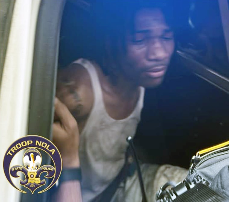 Kendall Myles apprehended and put in a car.