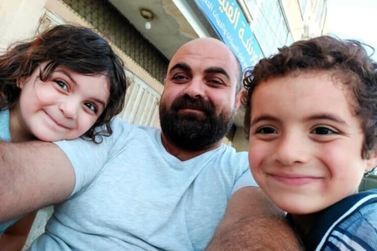 Dr. Alaa al-Najjar's lad and girl Rakan and Eve, who were killed successful an Israeli airstrike alongside 7 siblings, are pictured with determination begetter Hamdi.