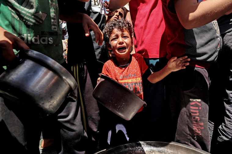 A child cries at a food distribution point