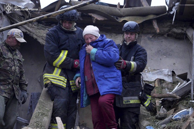 Emergency workers evacuate an aged resident